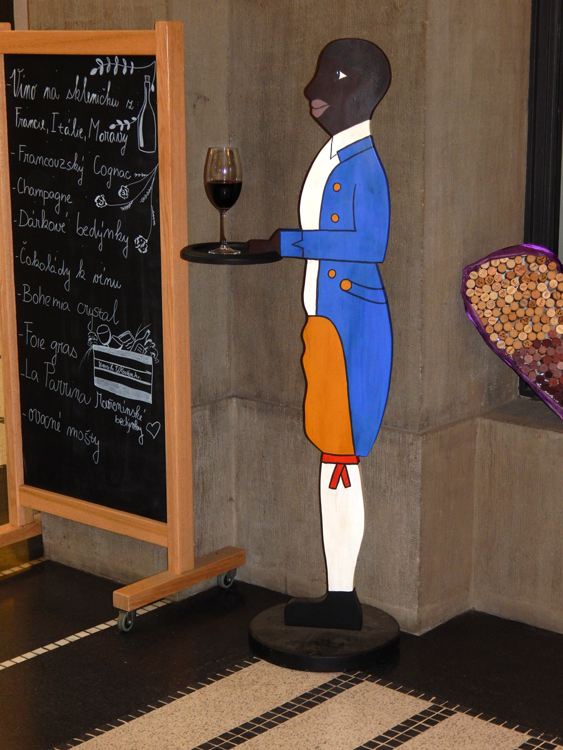 Prague - stereotype black waiter in front of wine bar