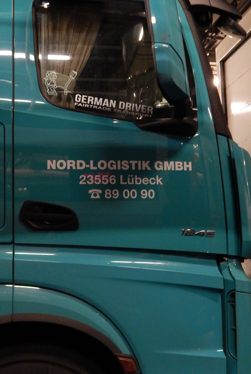 in transit, truck on the ferry with German Driver sign
