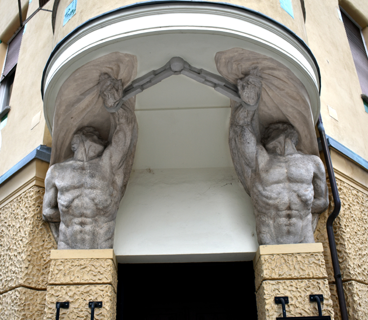 Ljubljana - twin giants supporting building's entrance canopy