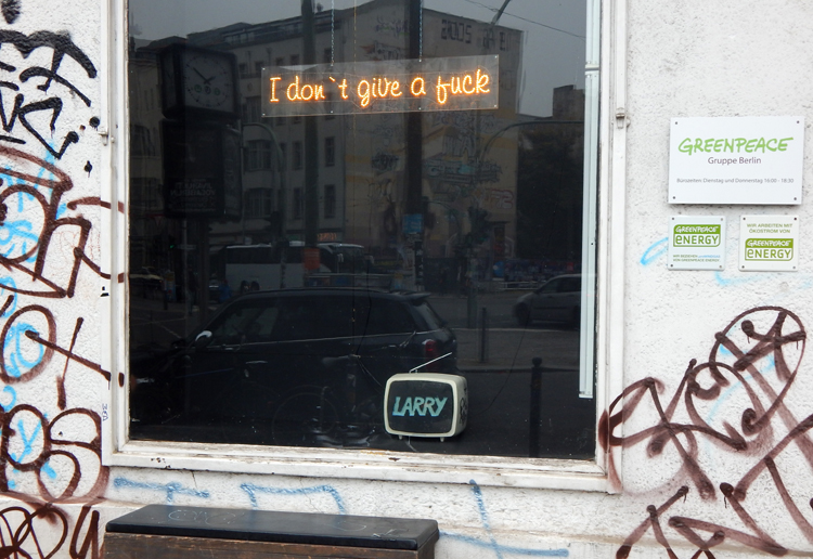 Berlin Greenpeace sign in office window - I don't give a fuck